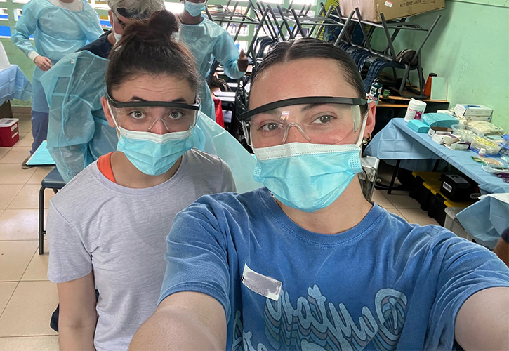${ two female students in mask at a clinic }
