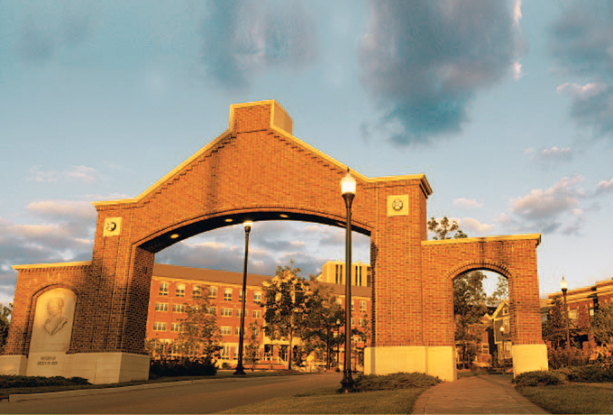 The front gate to the University with Keller Hall in the background