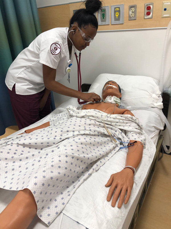 Nursing student examines a simulation patient