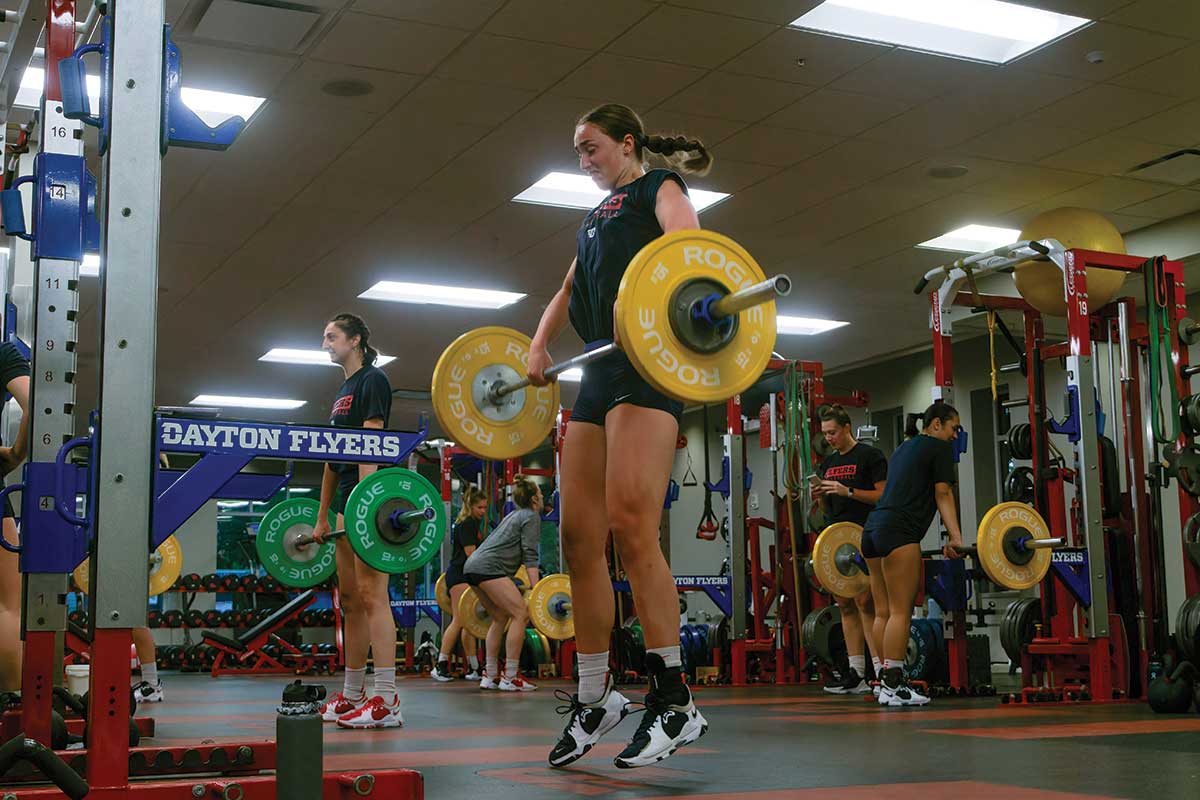 Women's volleyball player lifts weights