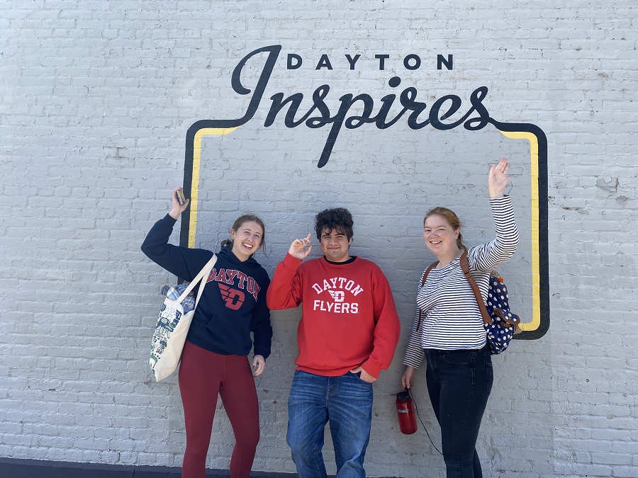 Students posing in front of Dayton Inspires sign