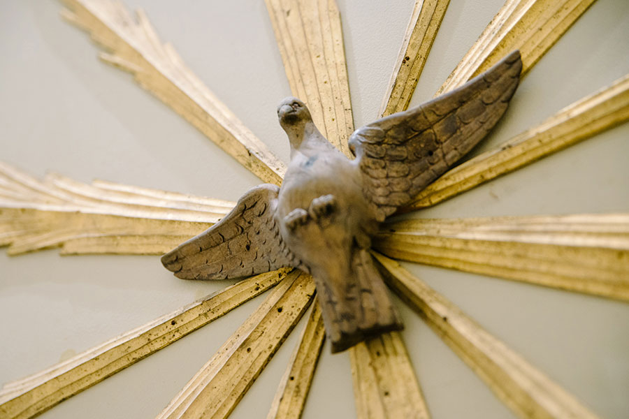 ${ Wooden sculpture of a dove inside the UD Chapel }