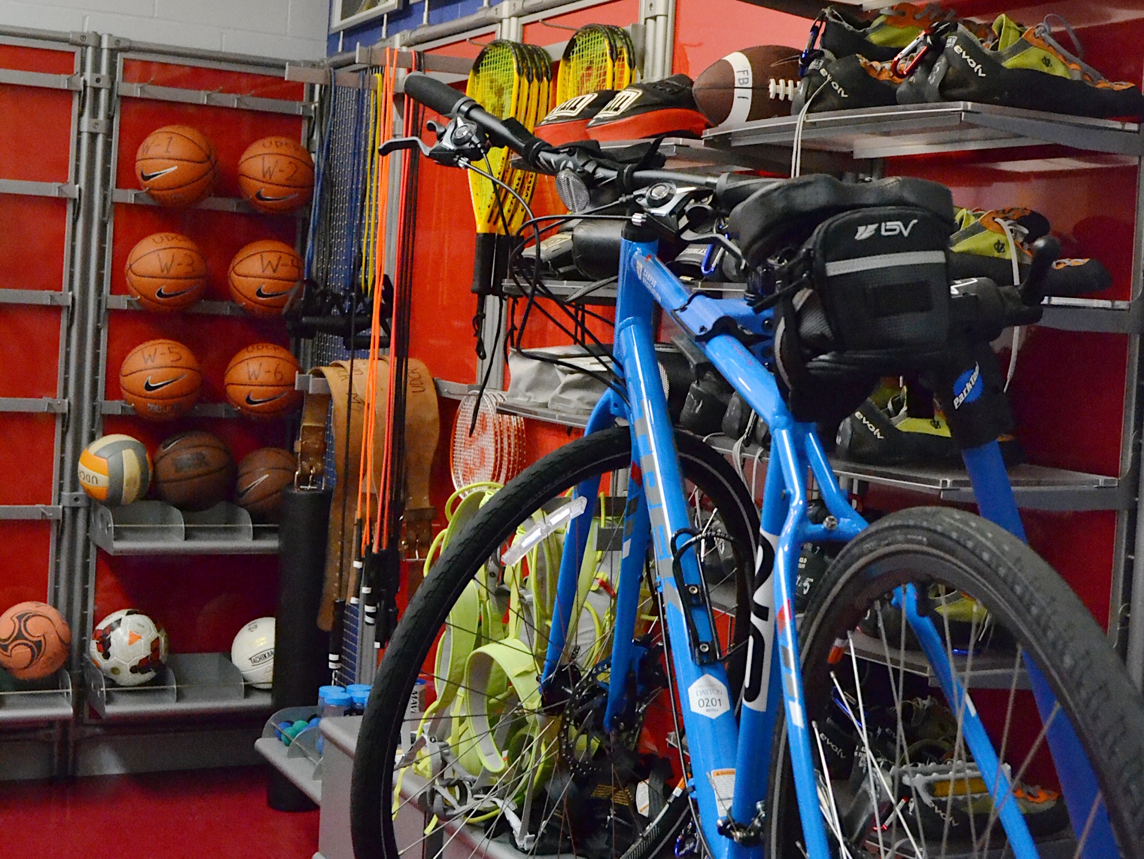 Image of the Equipment Resource Center with basketballs, bikes, tennis rackets, footballs, and more.